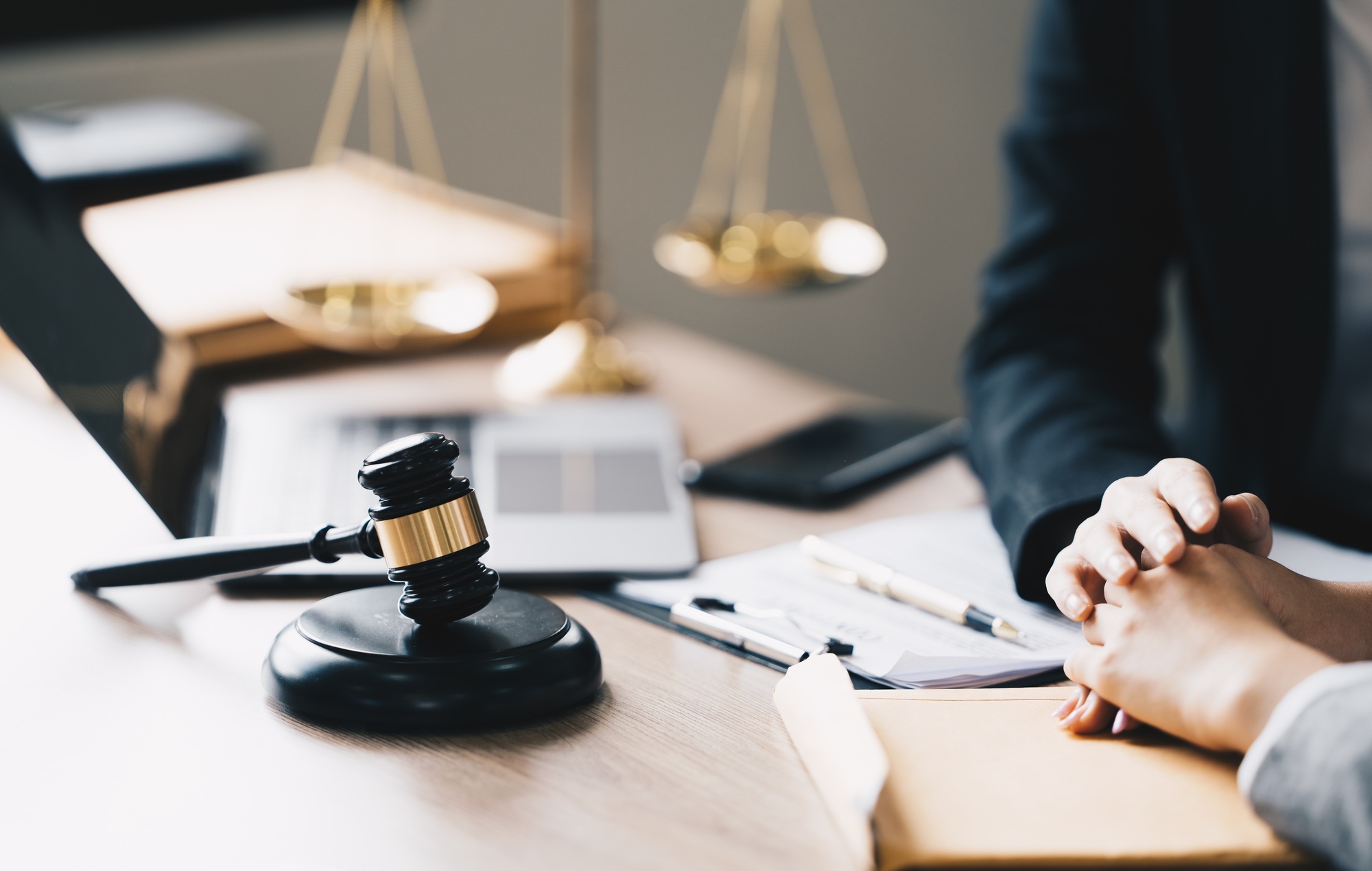 Female Lawyer Litigation Trial Lawyer office. Statue of Justice with scales and lawyer working on a